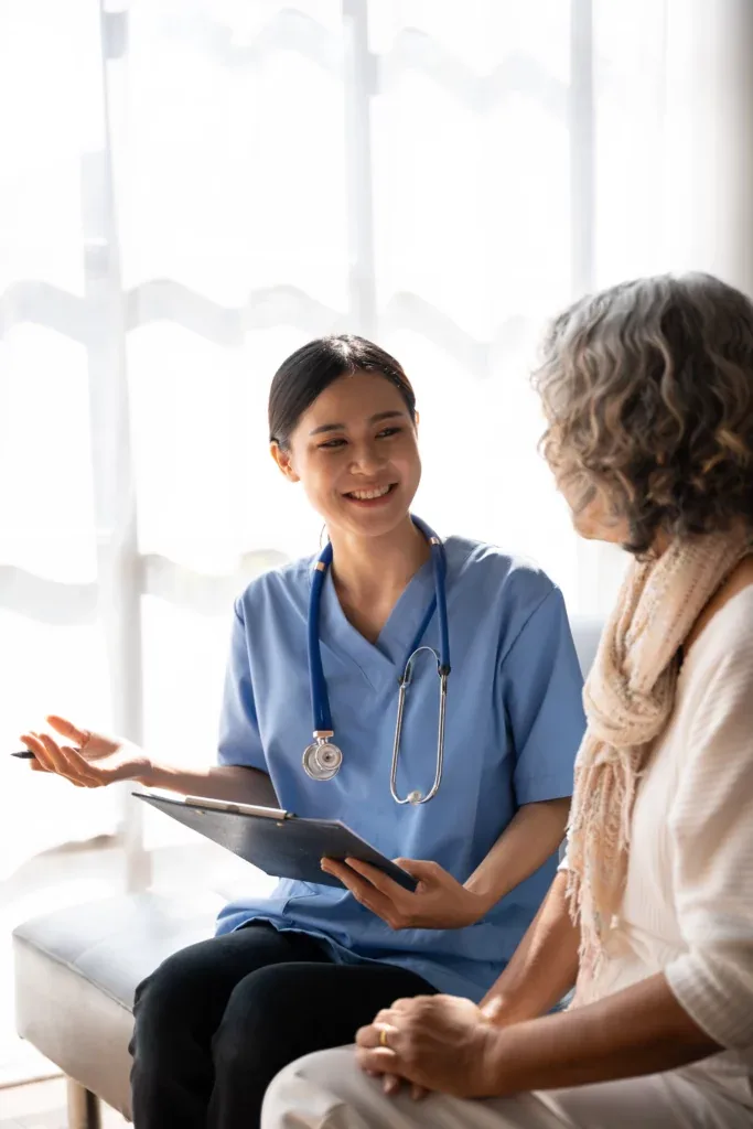 A nurse supporting an elderly patient